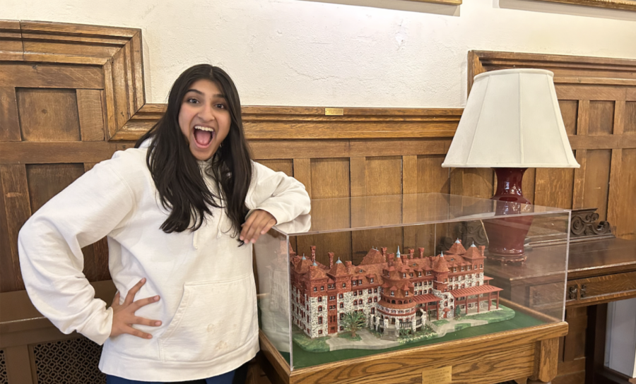 Riya Rao in 10th grade next to a miniature model of the Residence. 
